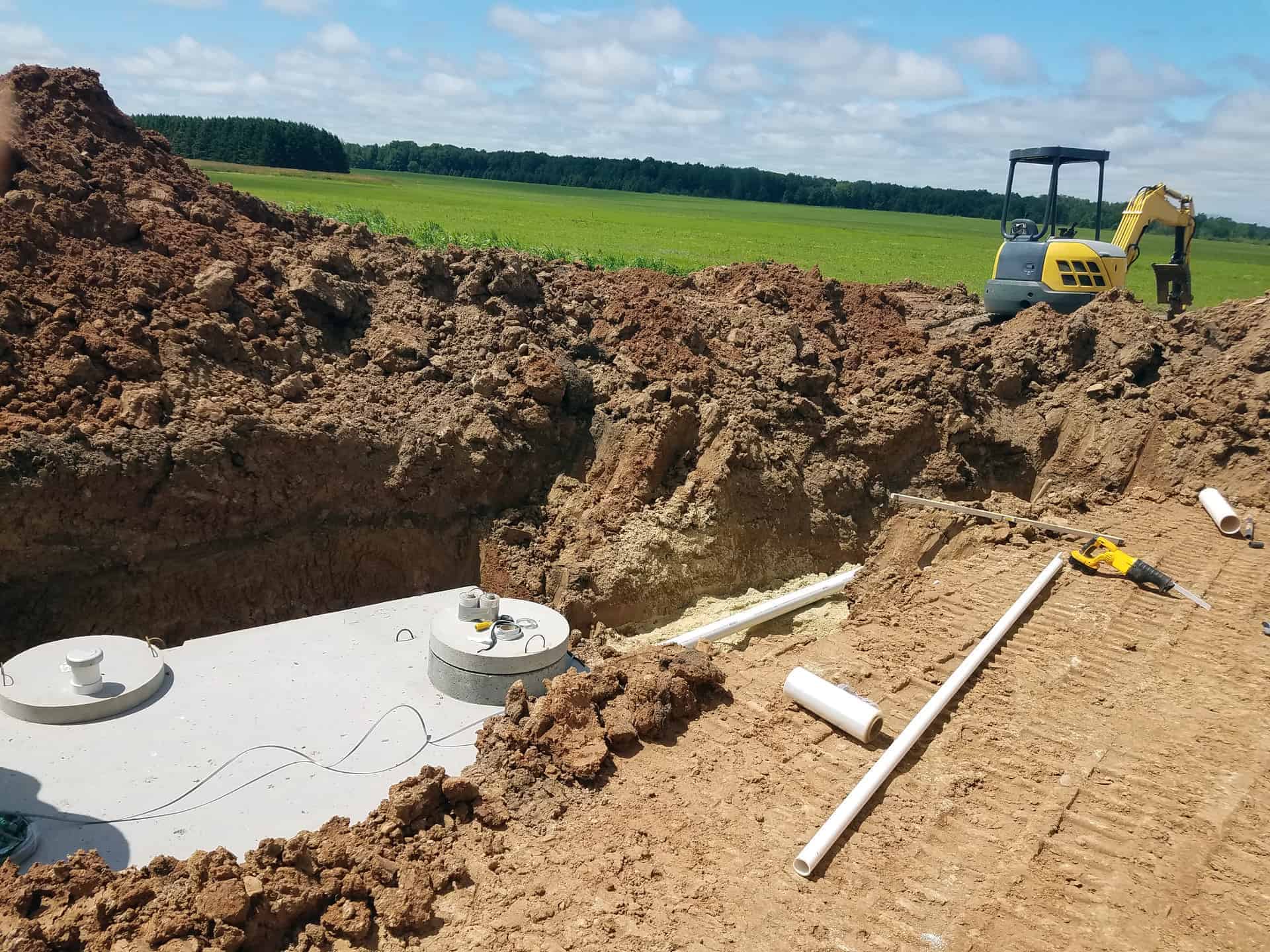 Concrete septic holding tanks being buried for site prep for a new mobile home