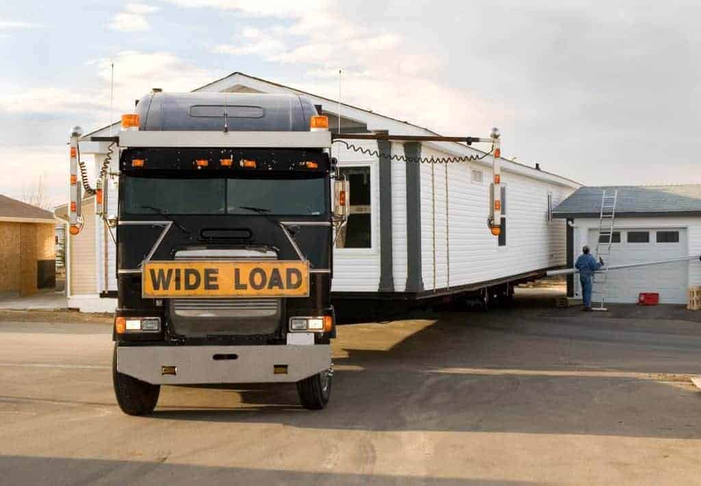 A single wide mobile home being delivered