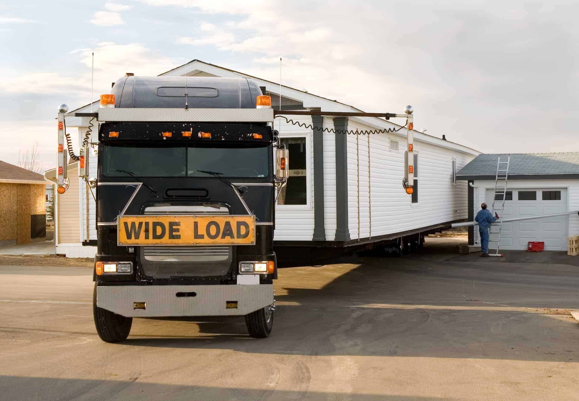 A single wide mobile home being delivered