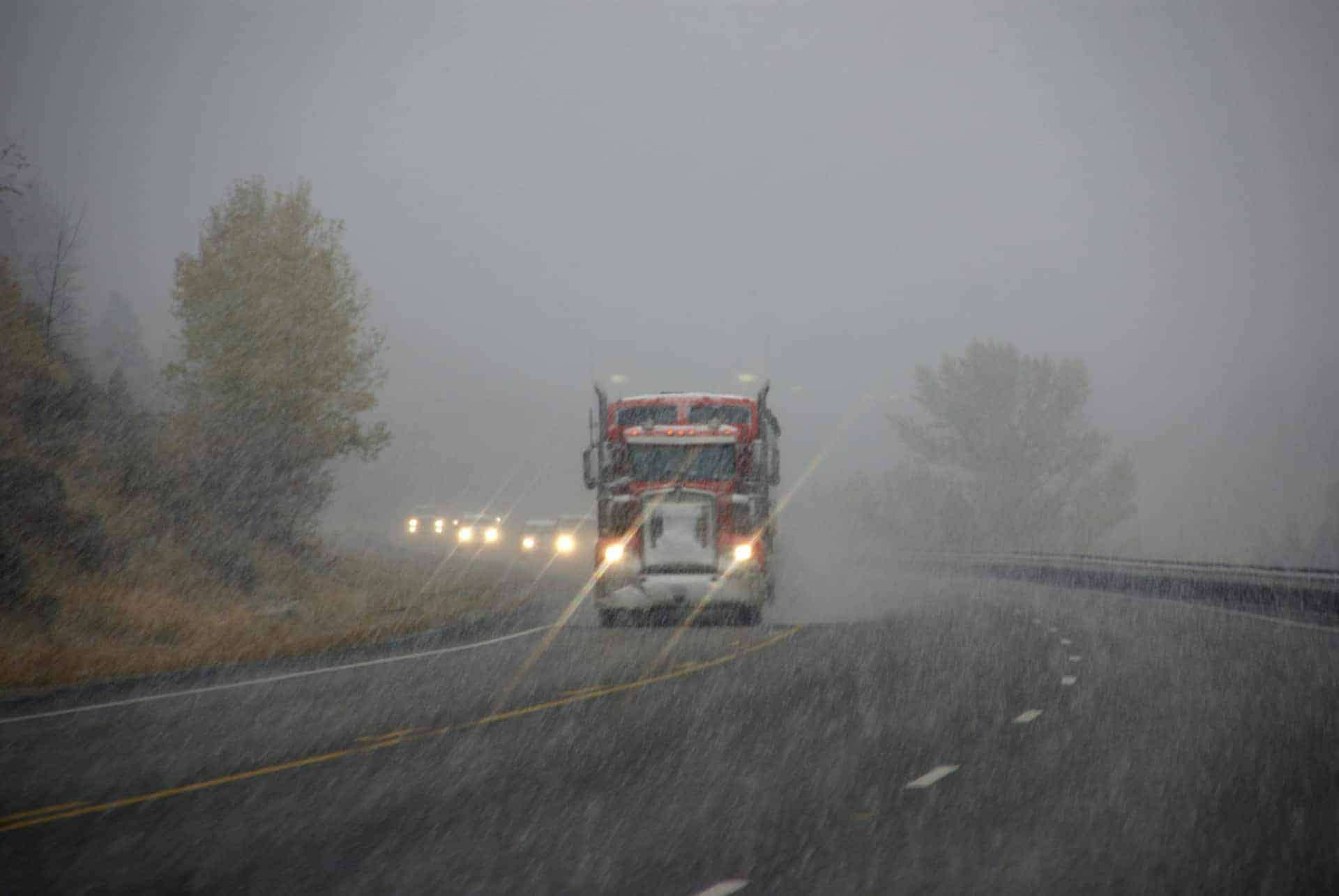 truck moving mobile home down highway to relocate