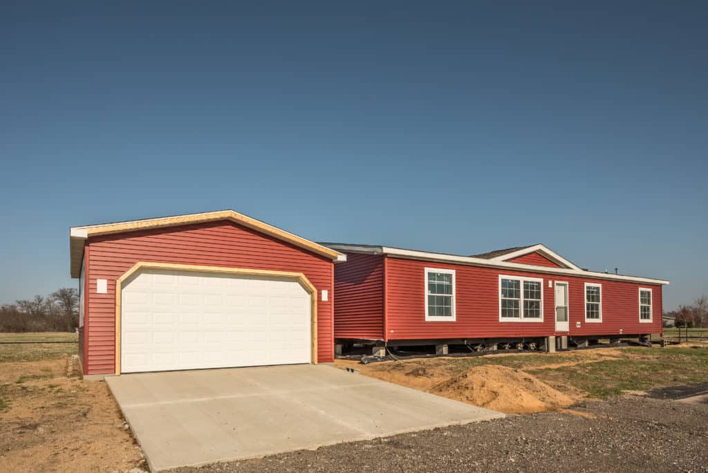 New manufactured home and stick built garage need finishing before owners can move in
