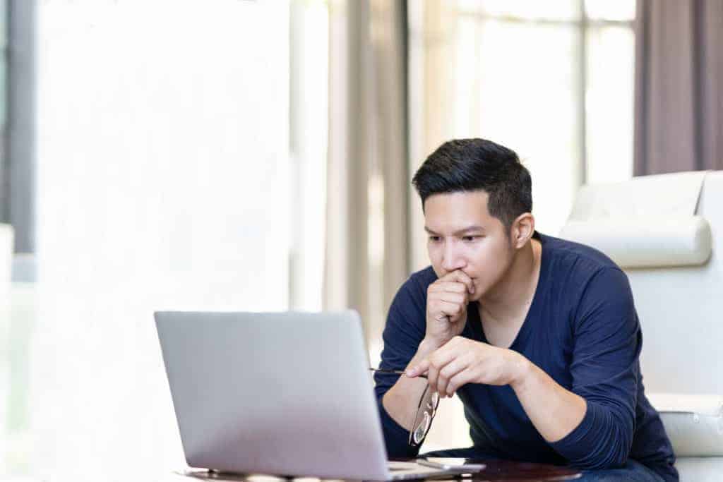 man looking at computer wondering about manufactured homes