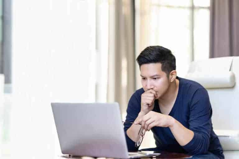 man looking at computer wondering about manufactured homes