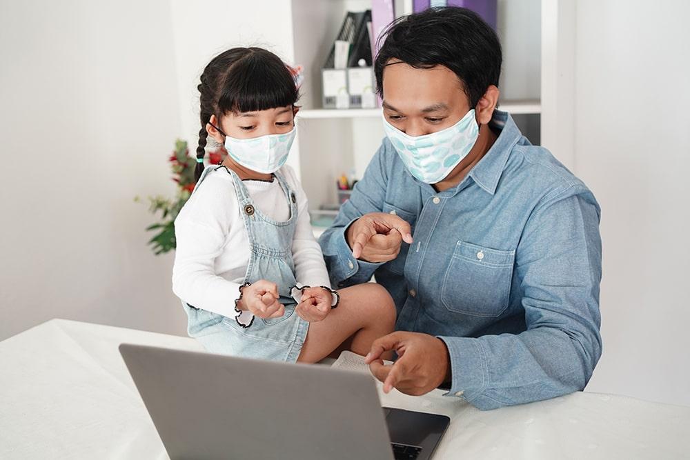 Father and daughter pointing on the laptop