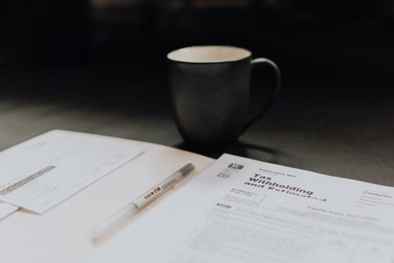 Black cup and tax papers