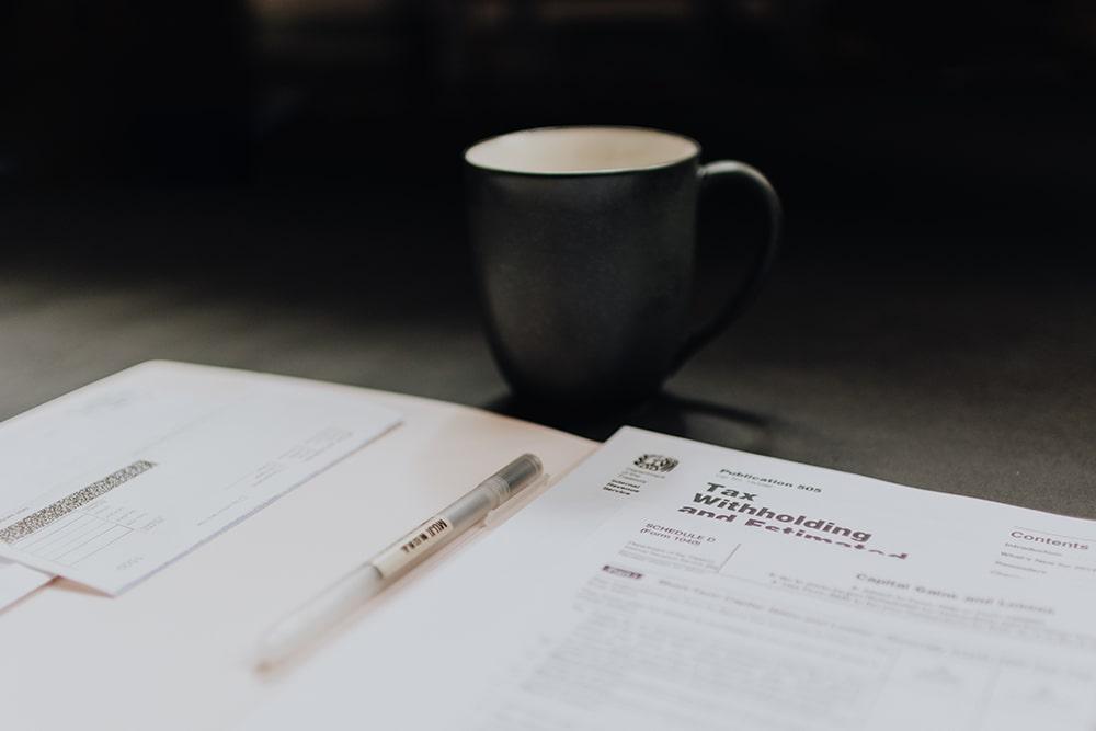 Black cup and tax papers