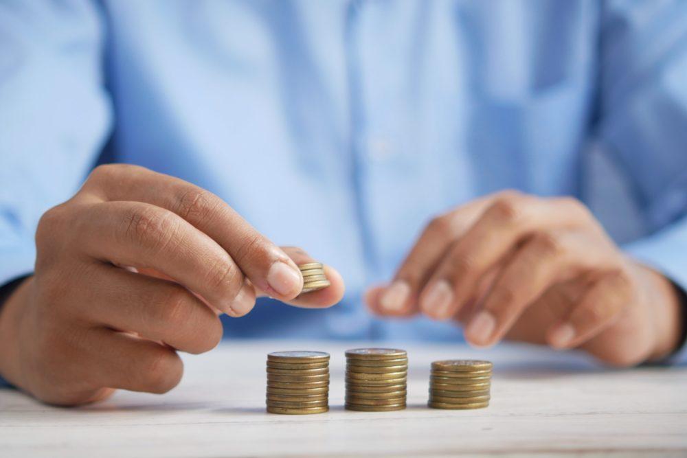 A man stacking up his coins