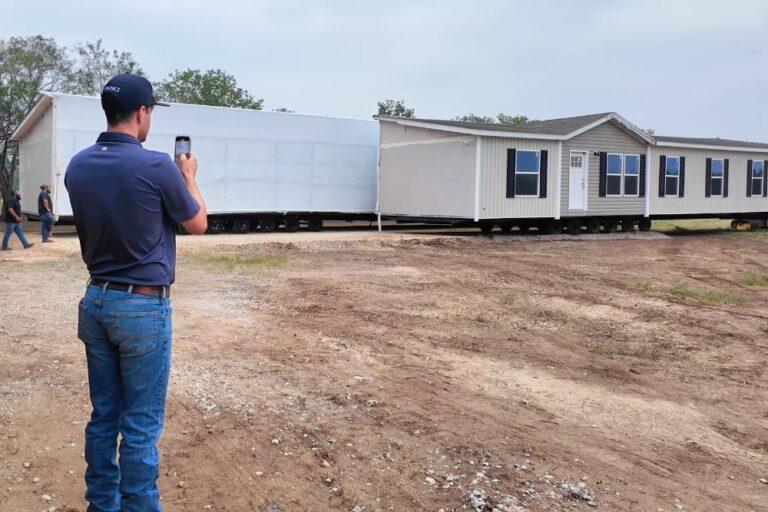 Jake Collier watching his new home the Clayton EPIC Summit being delivered to his property in San Antonio, Texas